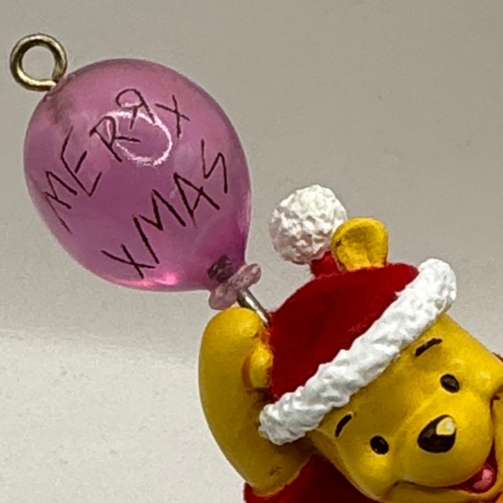 Winnie the Pooh figure ornament holding a balloon that says Merry Xmas - Picture 4 of 4